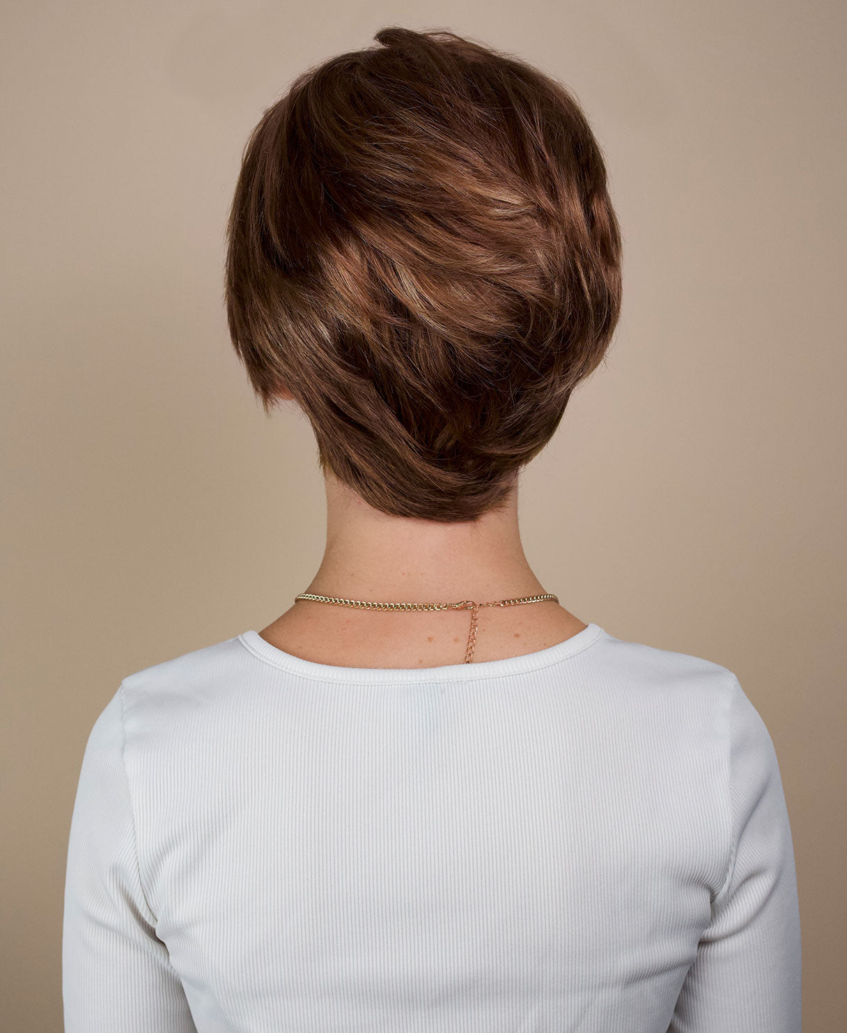 wedge cut human wig - 8" bronzed highlights.