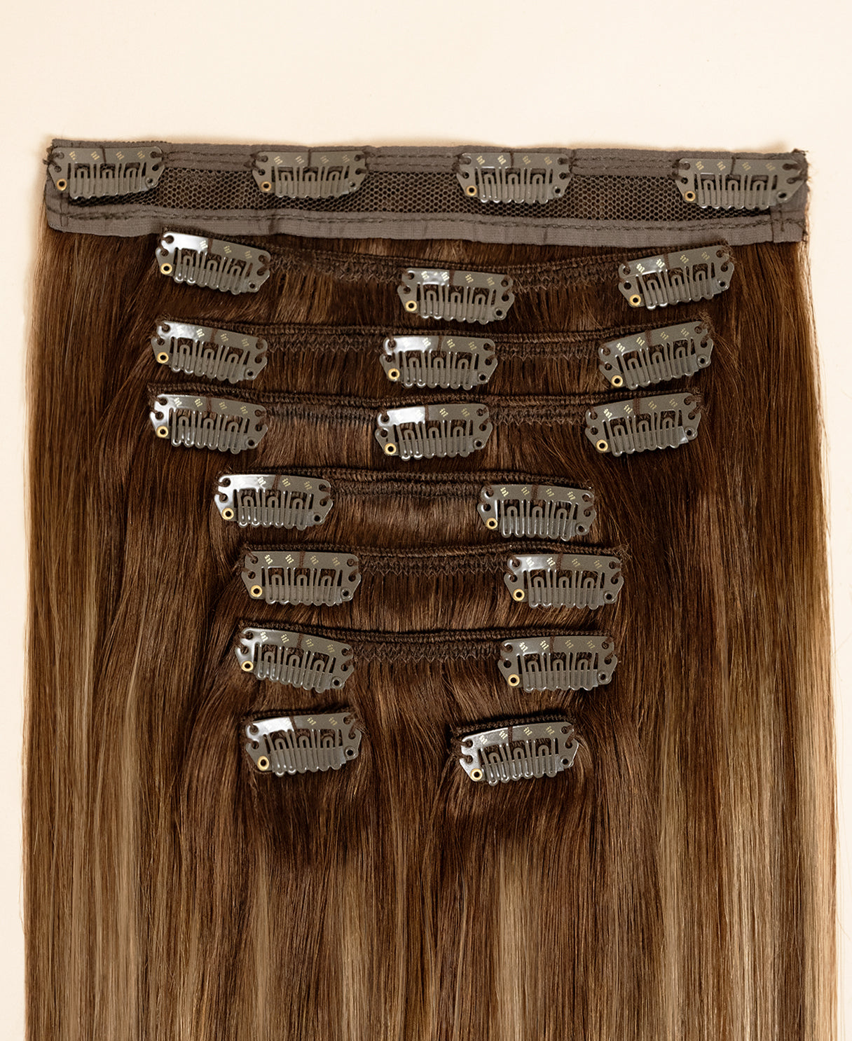 clip-in hair extensions rooted beige highlights.