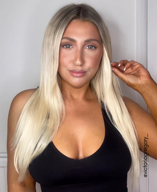 tape-in hair extensions rooted blonde.